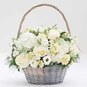 "Sympathy Basket in Creams: A heartfelt arrangement featuring soothing creams and seasonal flowers, expressing condolences with grace and compassion."