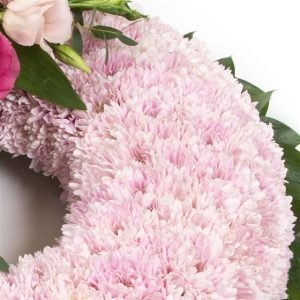 Pink Massed Wreath: A stunning wreath arrangement in various shades of pink, elegantly designed for a touch of warmth and grace."